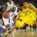 Kansas senior Elijah Johnson moves the ball around Michigan sophomore Trey Burke during the second half at Cowboys Stadium in Arlington, Texas on March 29, 2013. Melanie Maxwell I AnnArbor.com